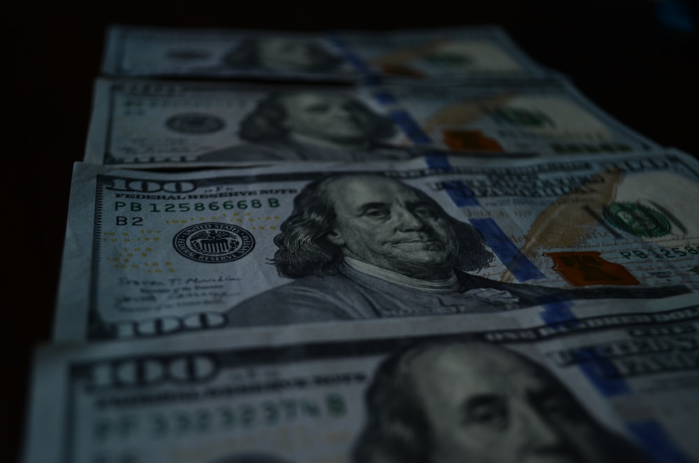 a stack of twenty dollar bills sitting on top of a table