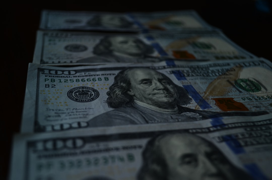 a stack of twenty dollar bills sitting on top of a table,