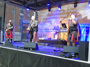 a group of men standing on top of a stage