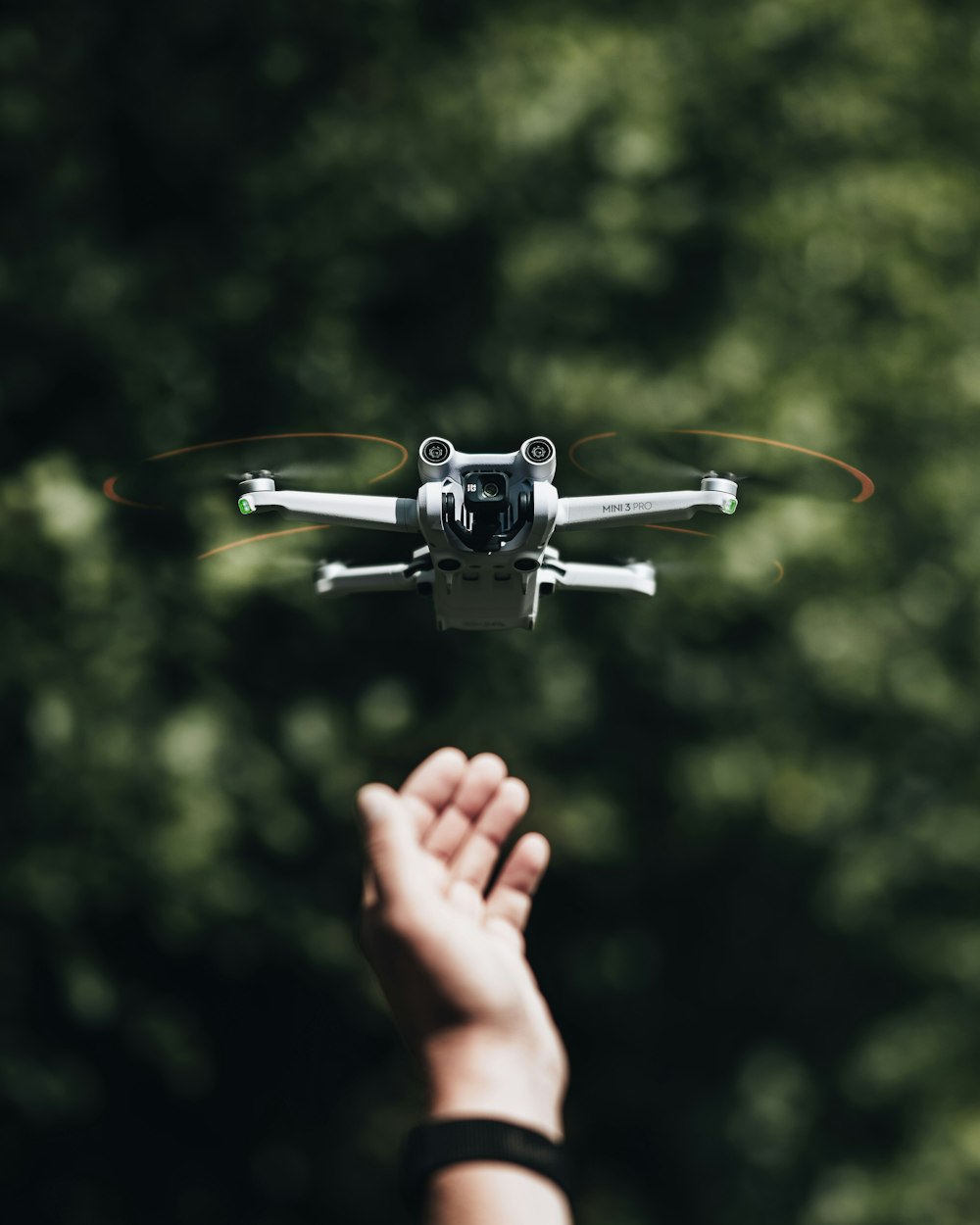 a person holding their hand up to a flying toy