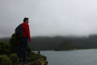 An adventurous hiker standing on a cliff.