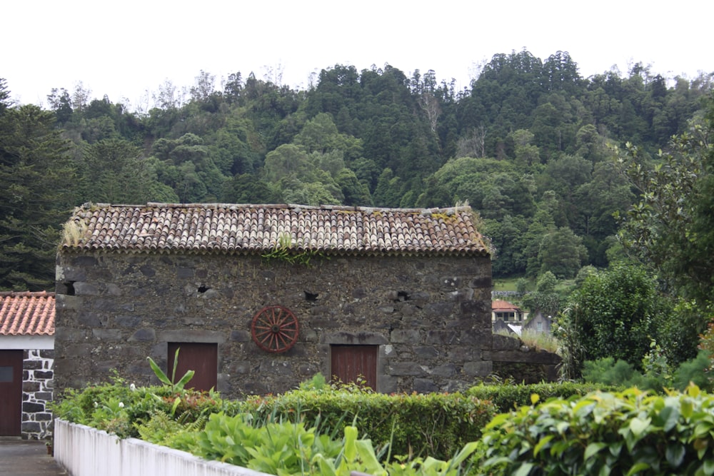 a stone building with a wheel on the front of it