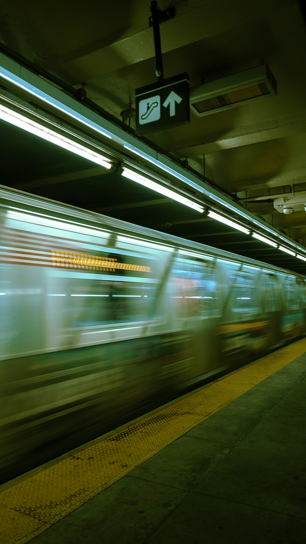 a blurry photo of a subway train passing by