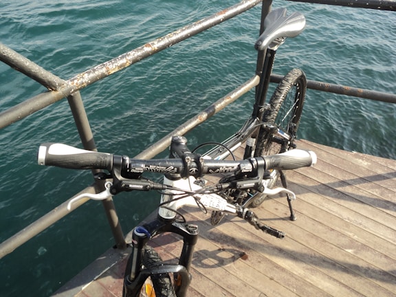Cliff muddy bike parked beside a city street, showing its versatility.