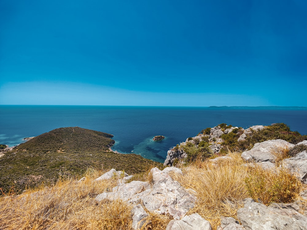 a view of the ocean from the top of a hill