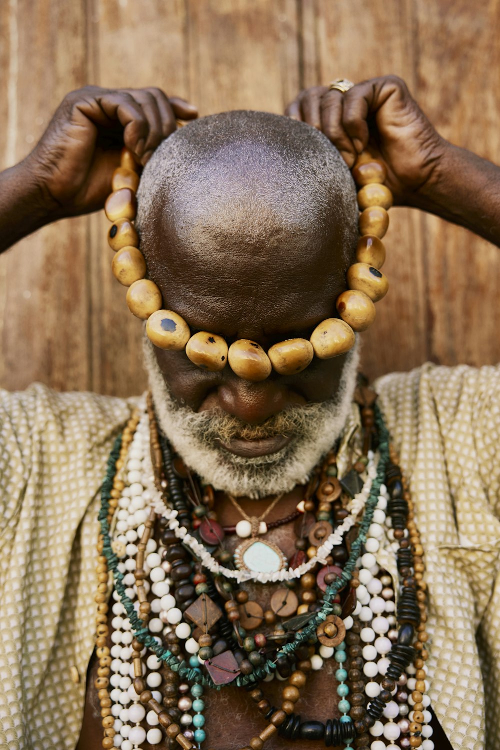 a man with a necklace on his head
