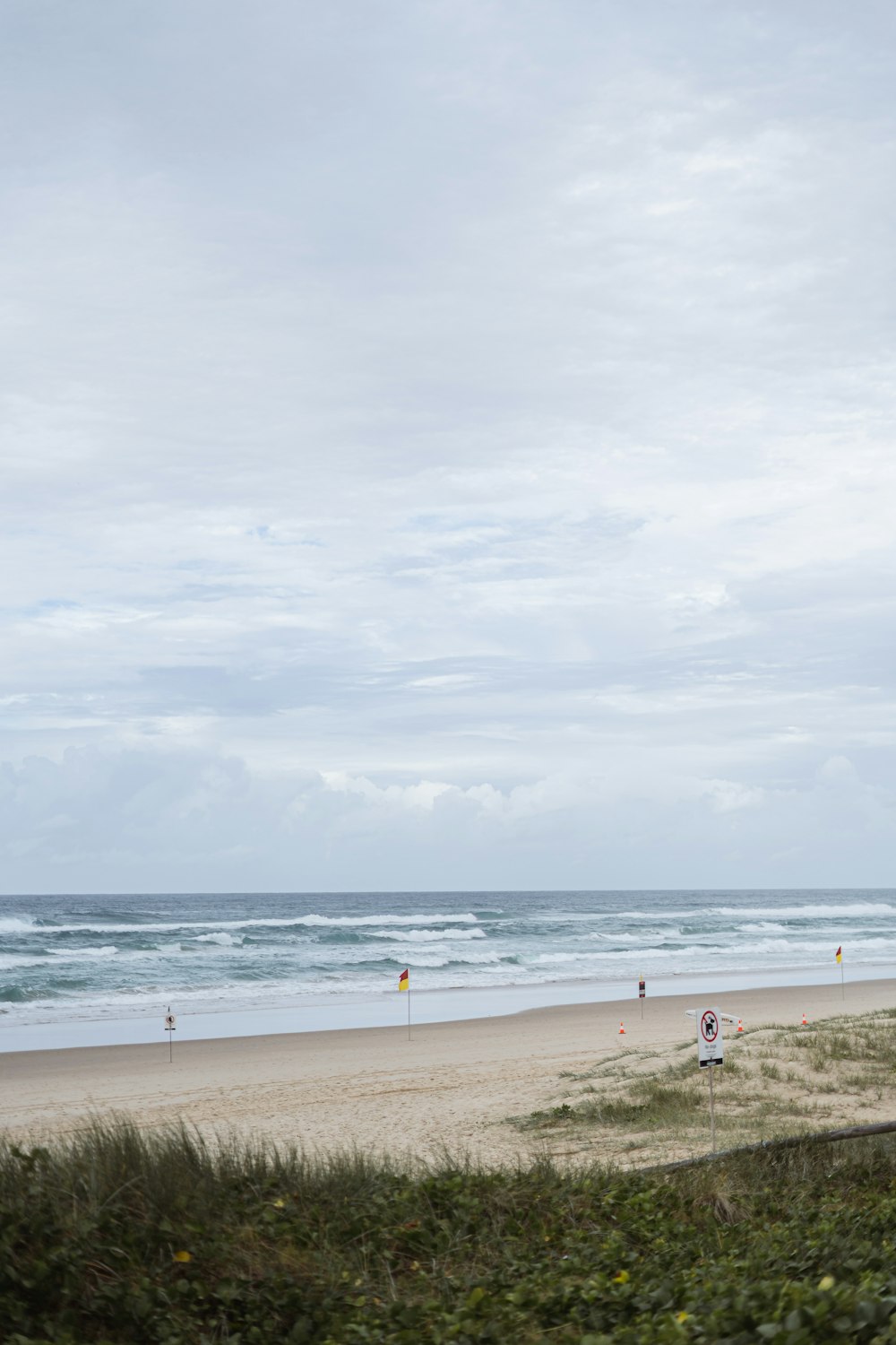 a group of people standing on top of a sandy beach