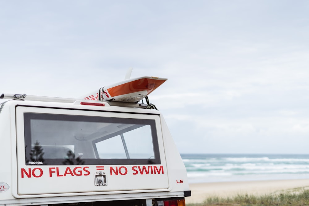 a white truck parked on top of a sandy beach