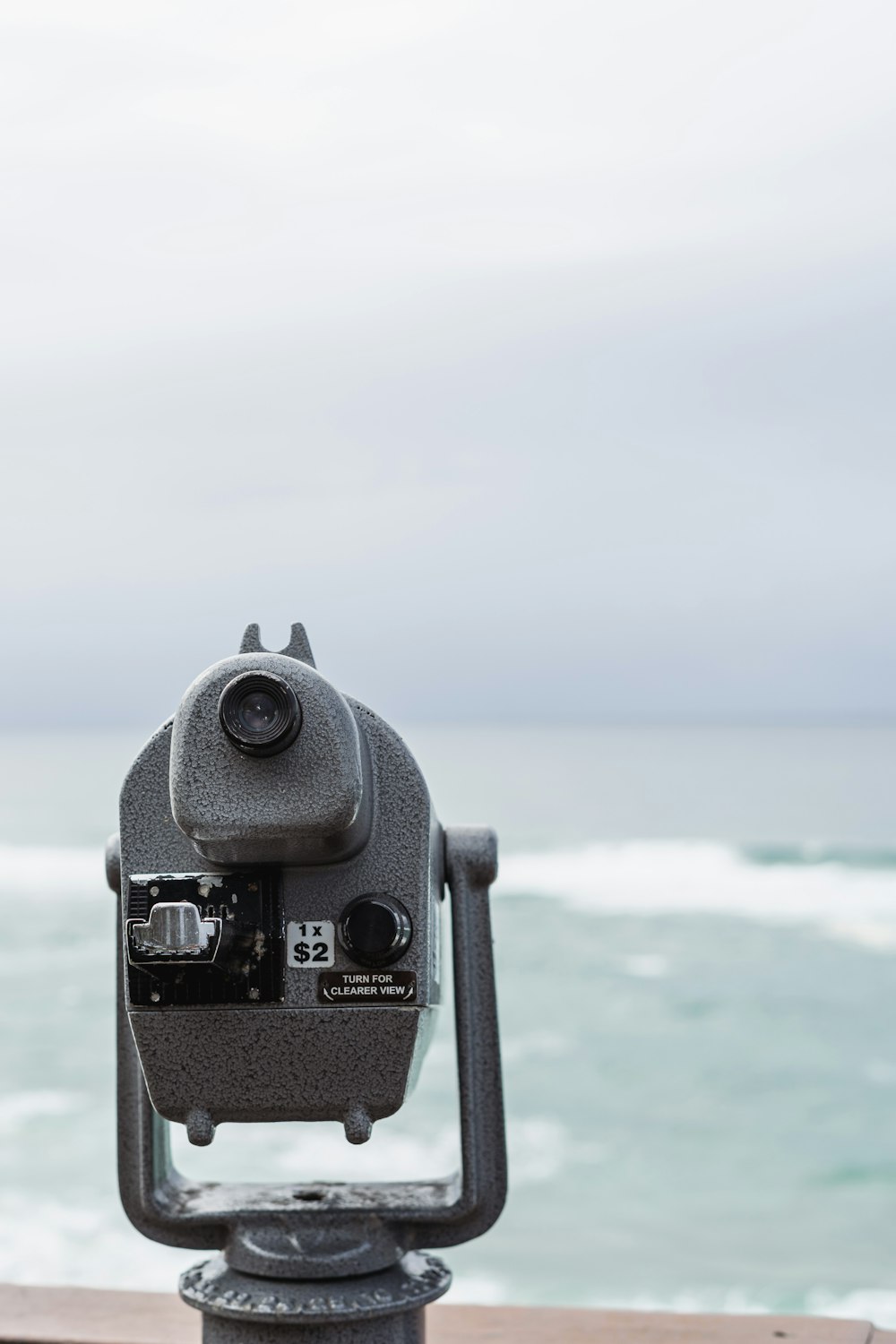 a pair of binoculars sitting on top of a wooden table