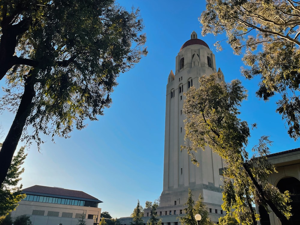 a tall white clock tower towering over a city