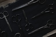 An overhead shot of all personal care scissors laid out with natural light highlighting their sharp edges.