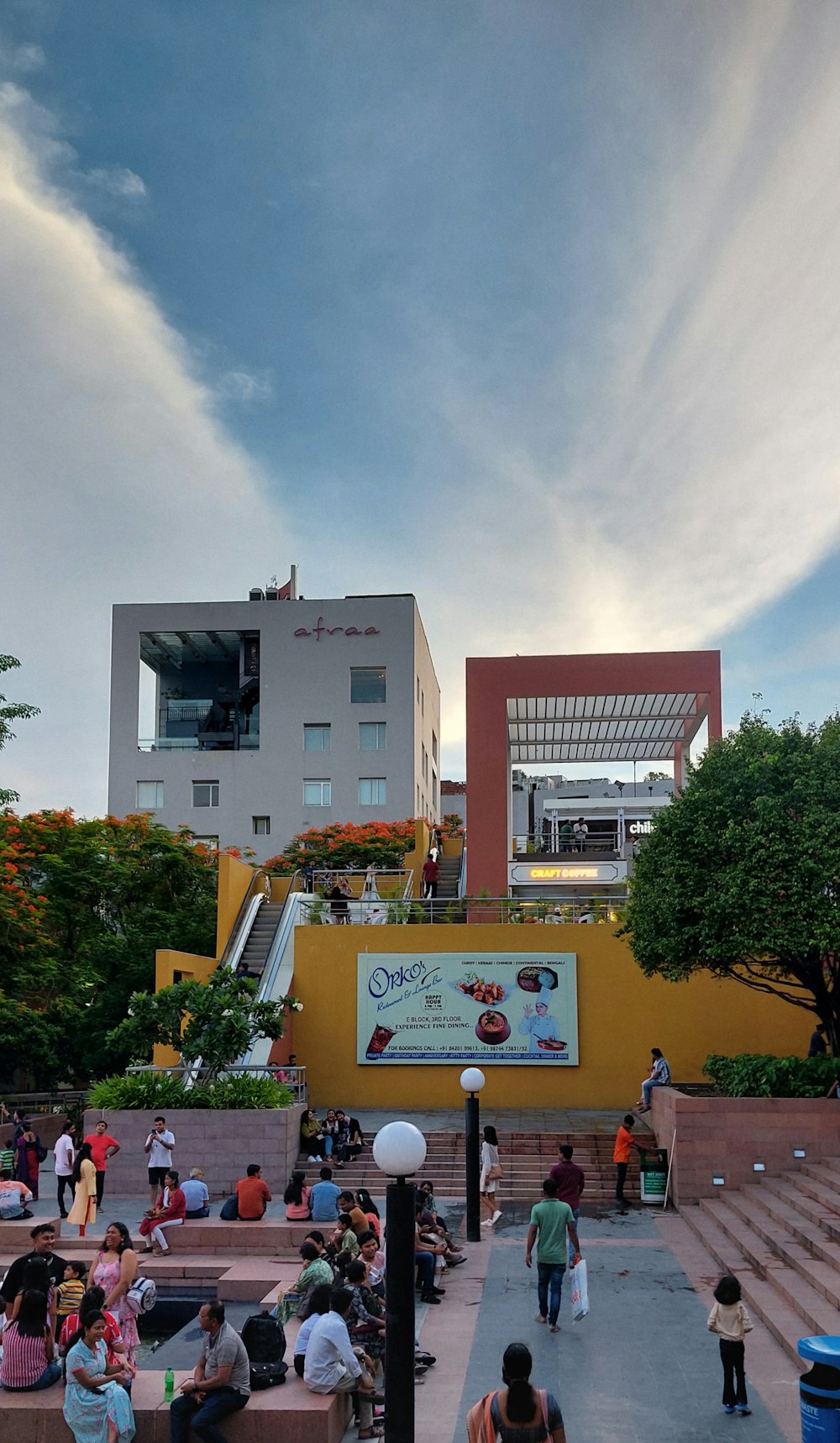 a group of people sitting on steps in front of a building