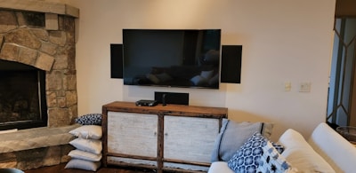 a living room with a fireplace and a flat screen tv