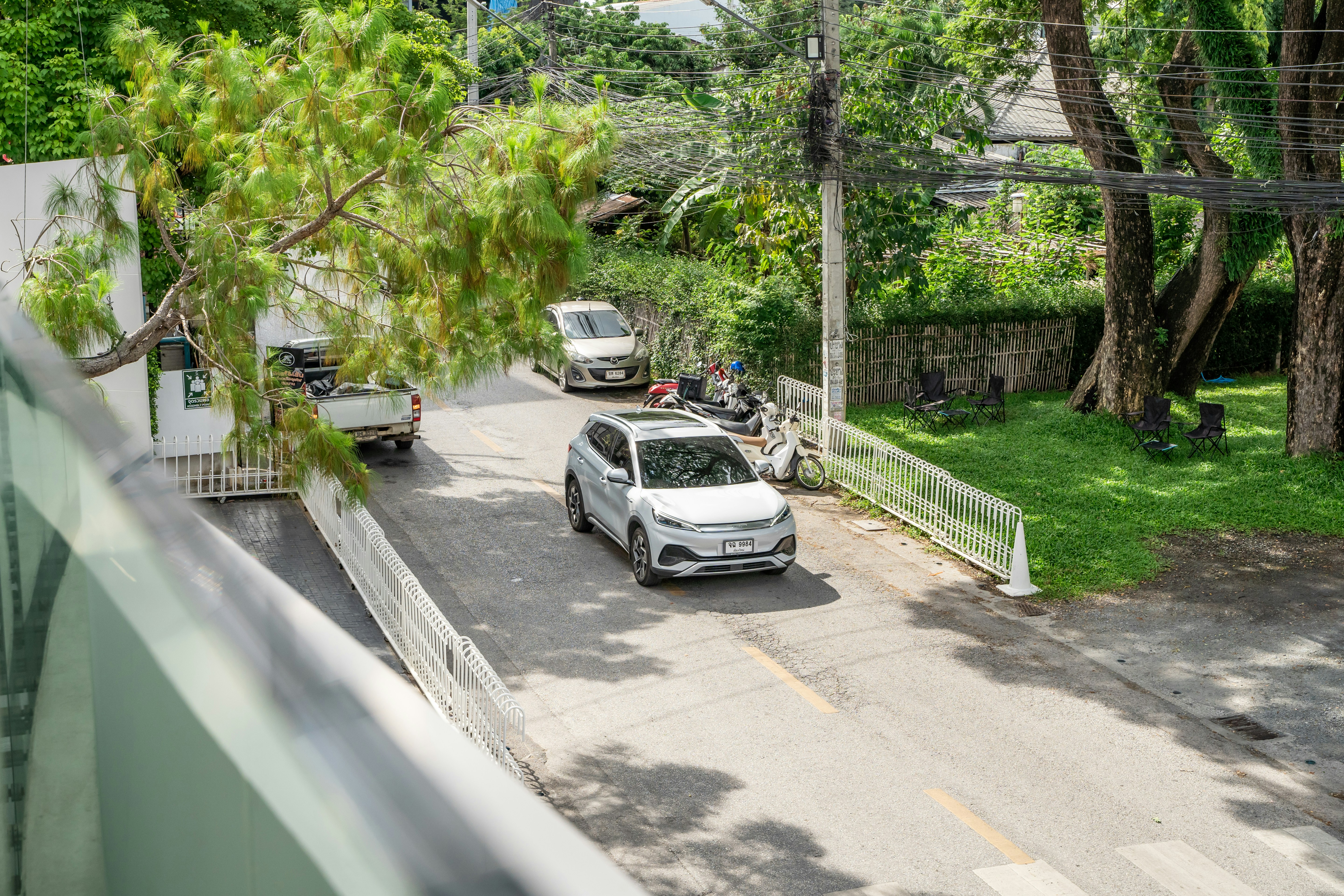 Family sedan parked in a suburban driveway with trees in the background