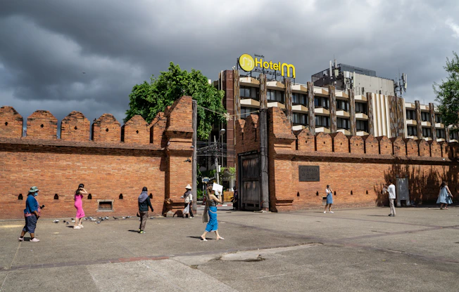 a group of people walking in front of a brick building