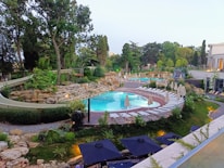 A beautiful finished swimming pool surrounded by lush greenery in Verona.
