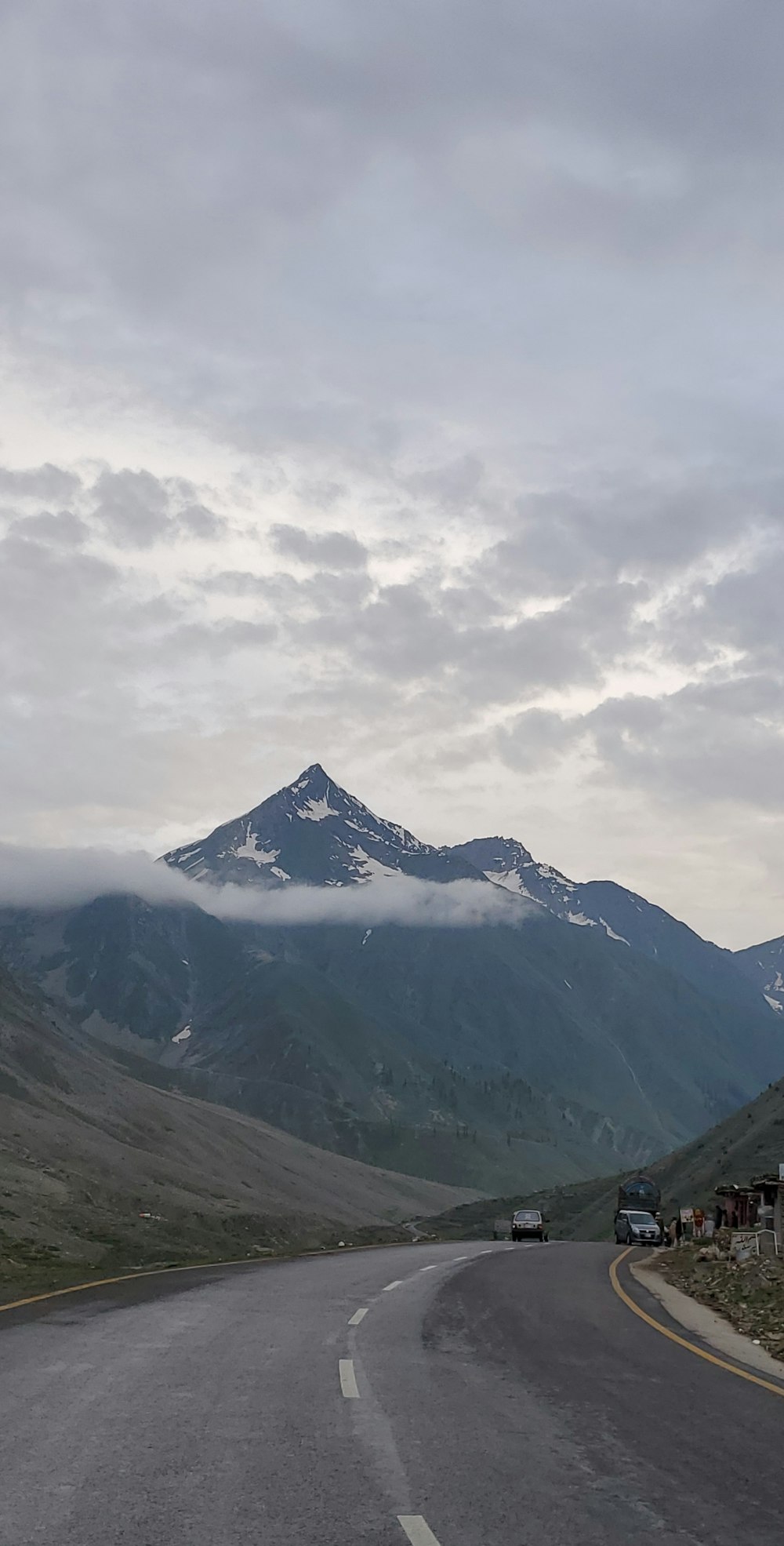 a road with a mountain in the background