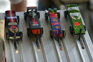 An action shot of multiple Hot Wheels cars racing down a looped track