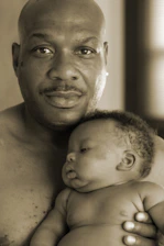 A caring father and son sharing a warm moment at home.