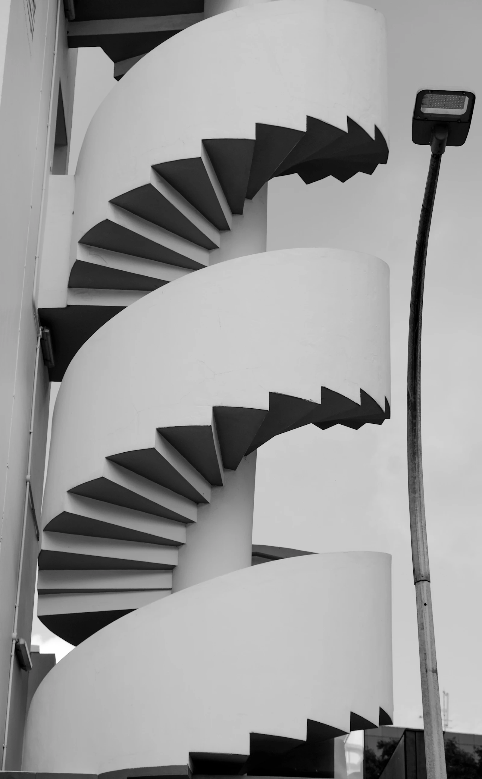 A black and white photo of a spiral staircase