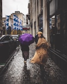 A rainy day in Buenos Aires with wet streets and people carrying colorful umbrellas