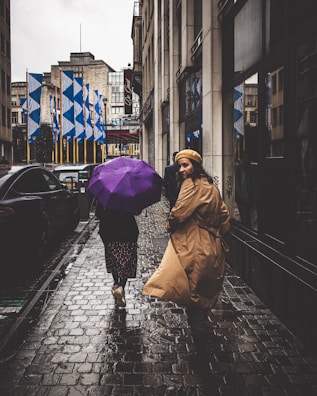 A rainy day in Buenos Aires with wet streets and people carrying colorful umbrellas