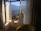 A relaxed man enjoying fresh air by an open window in a clean, odor-free room.