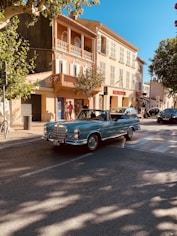 a blue car parked on the side of a street