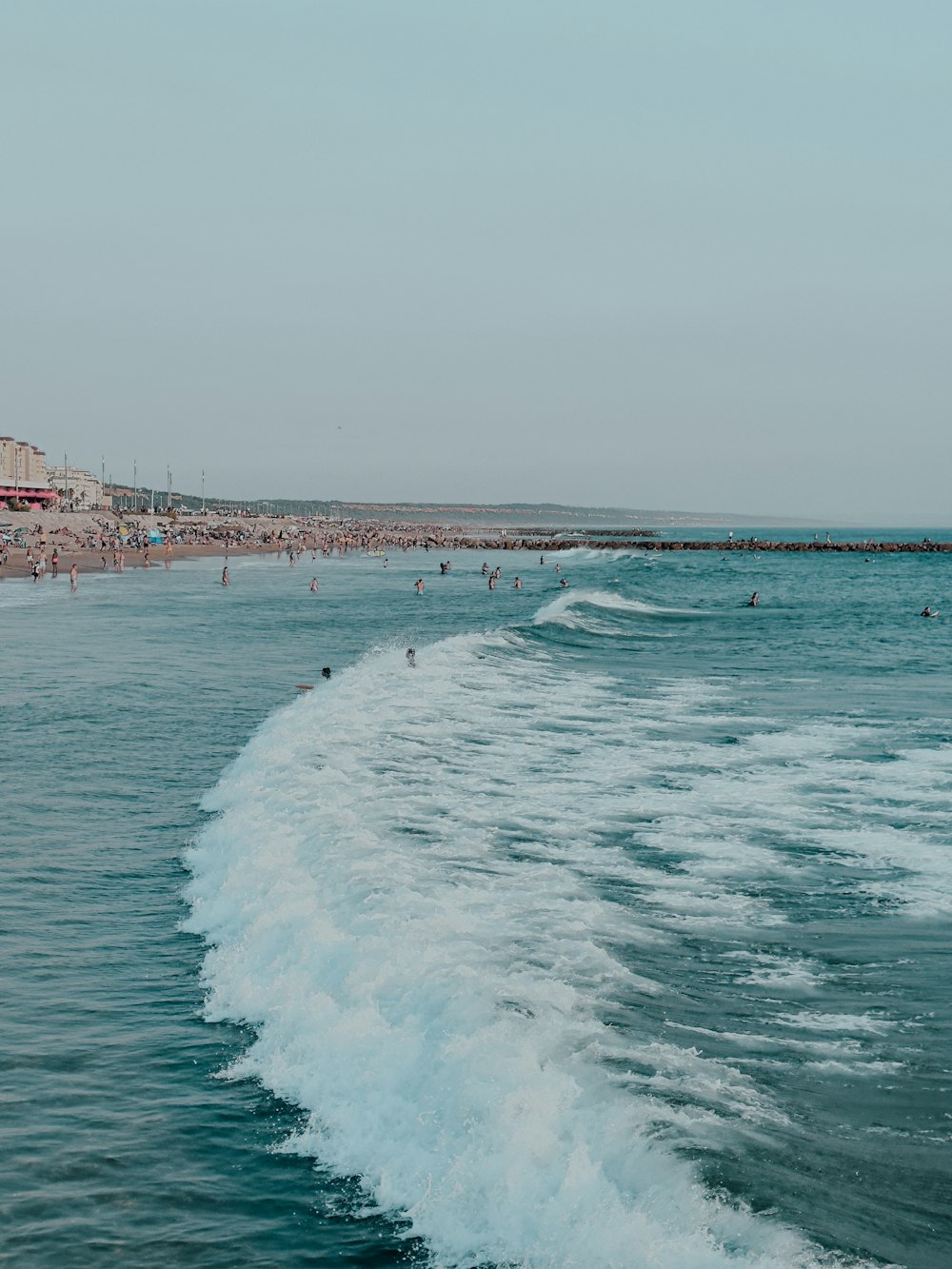 a group of people swimming in the ocean