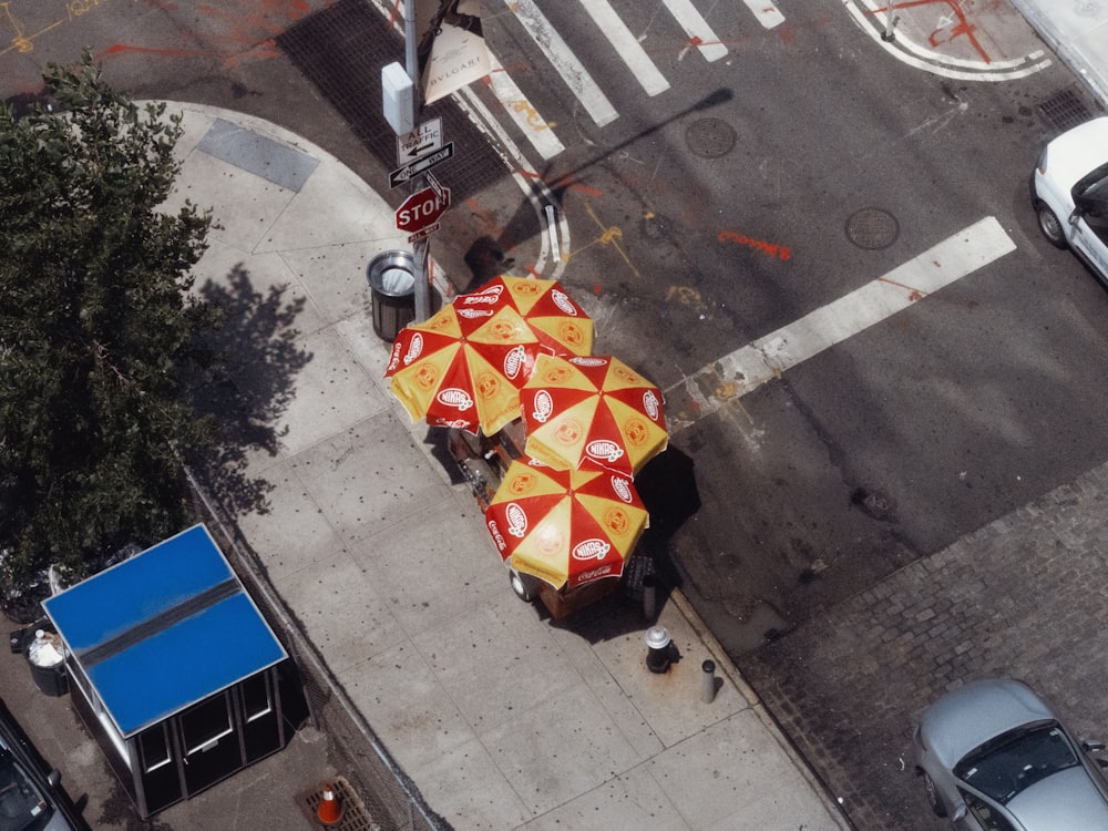 an overhead view of a red and yellow umbrella