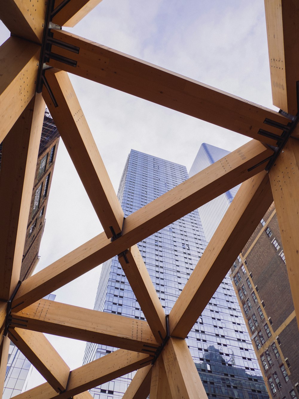 a view of a building through a wooden structure