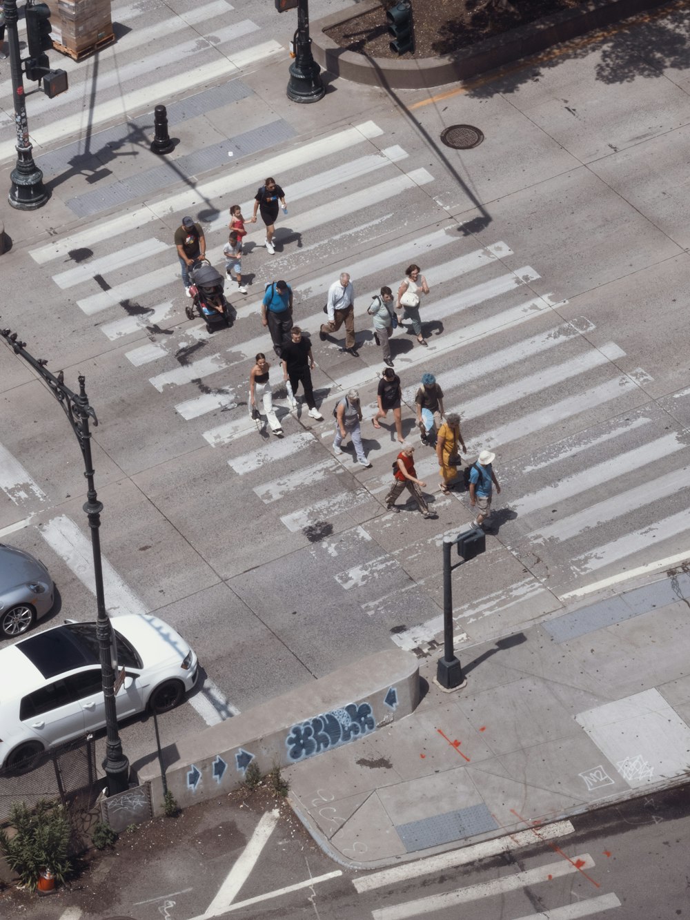 a group of people walking across a street