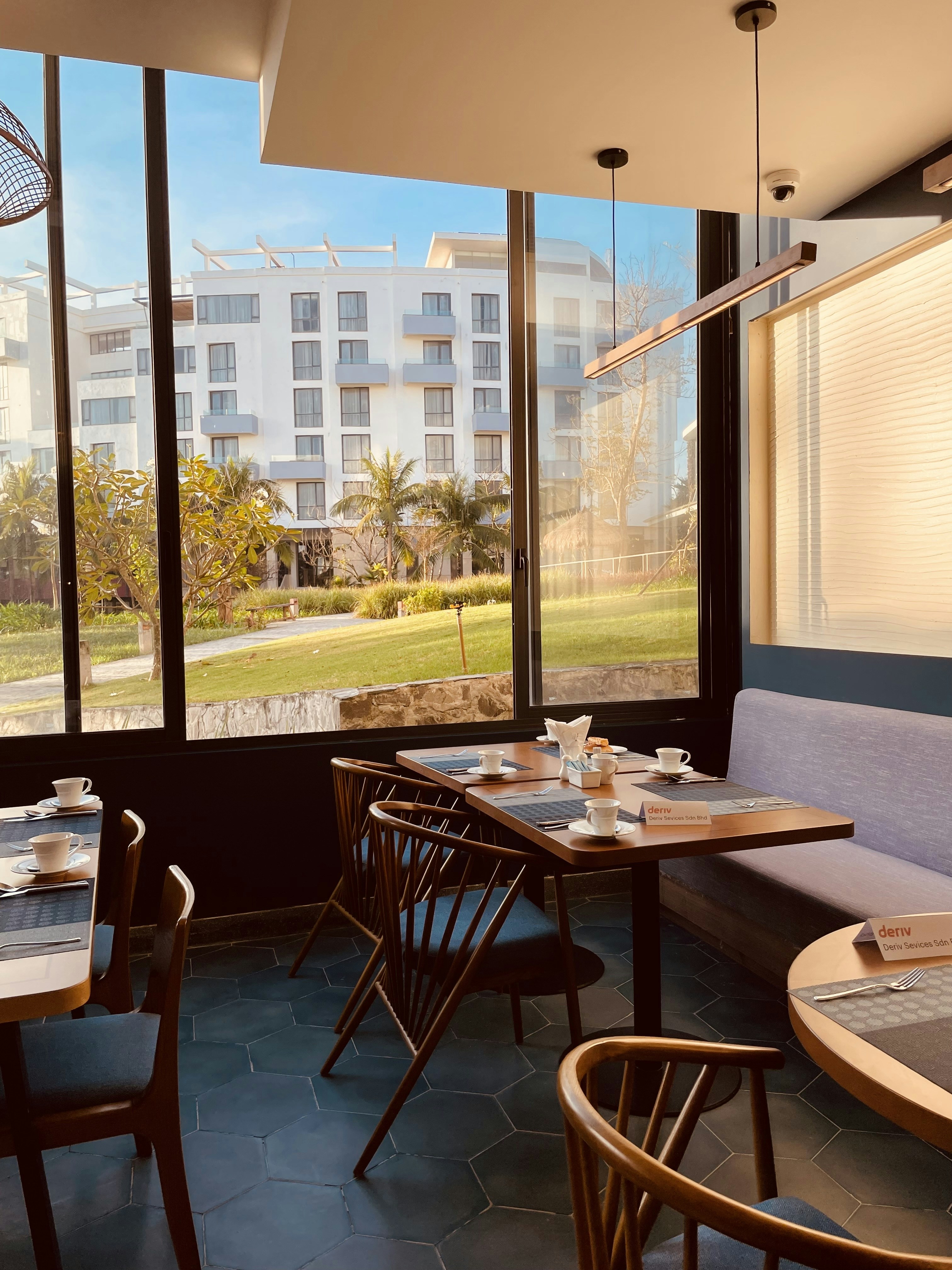 a restaurant with a view of a park outside the window