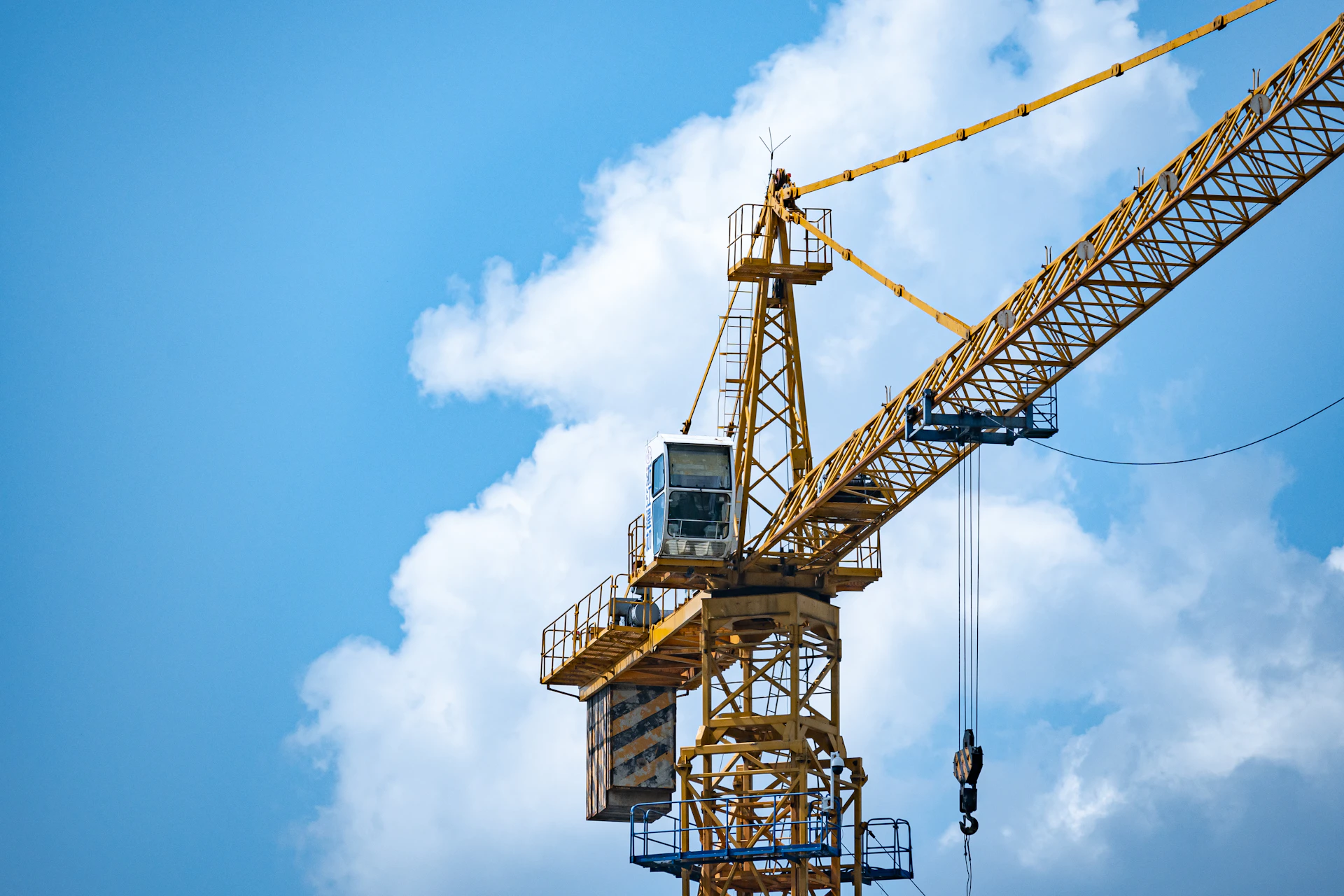 a yellow crane with a blue sky in the background