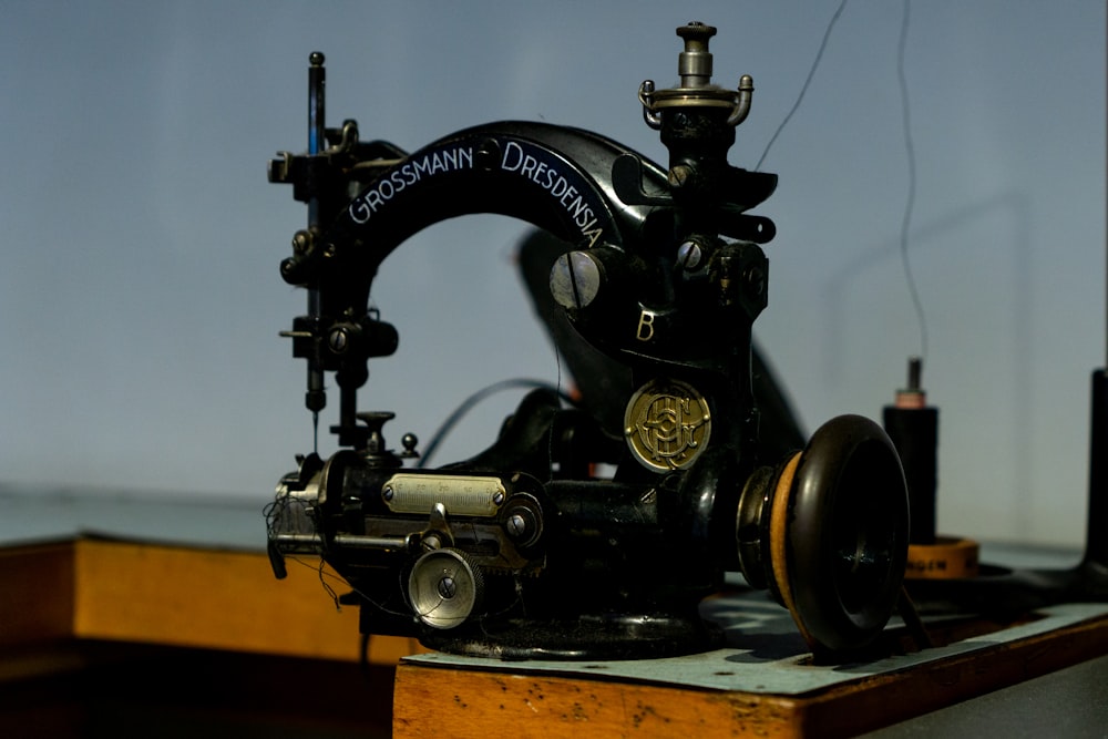 an old sewing machine sitting on top of a wooden table
