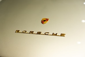 Close-up of a matte black Porsche 911 GT3 with its hood open, revealing the pristine engine bay.