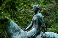 A serene image of Rani Lakshmibai on horseback, draped in green and white, symbolizing strength and grace.
