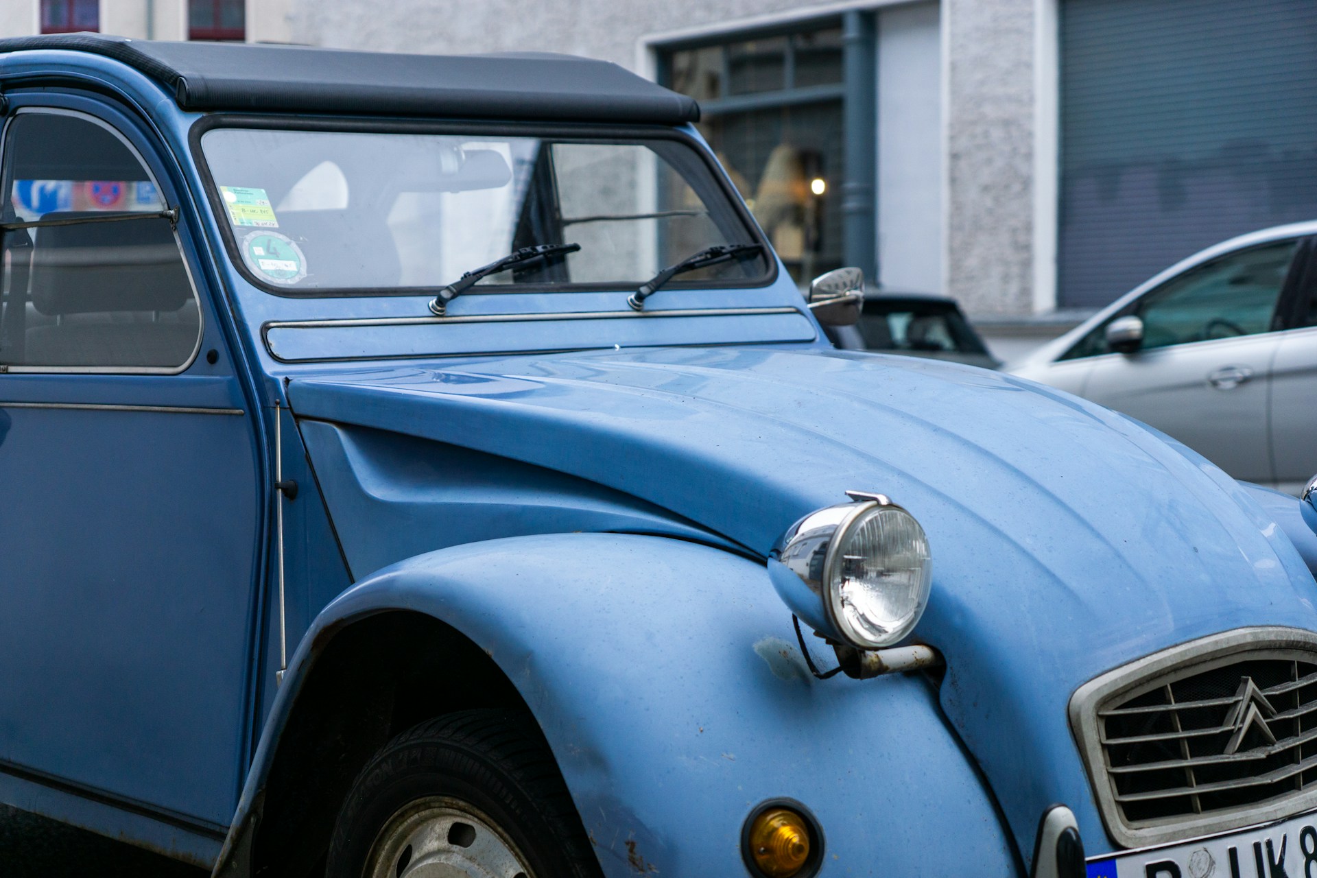 a blue car parked on the side of the road