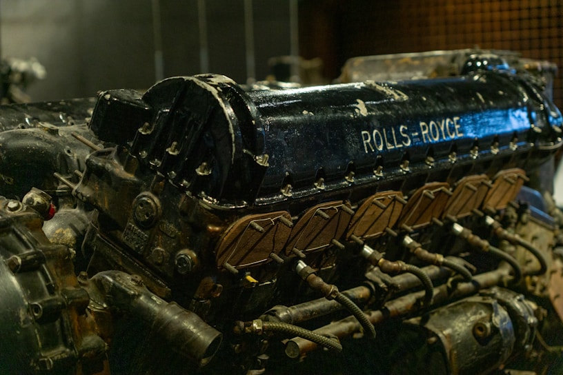 Close-up of a Rolls Royce turbine gleaming under industrial lighting.