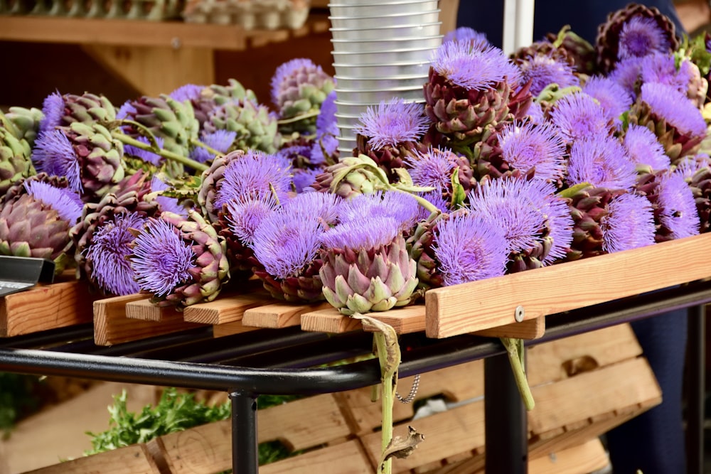 a bunch of purple flowers sitting on a table