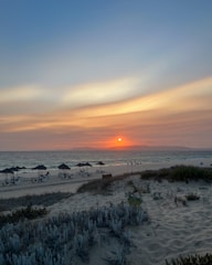A serene beach with a sunset, symbolizing relaxation and travel.