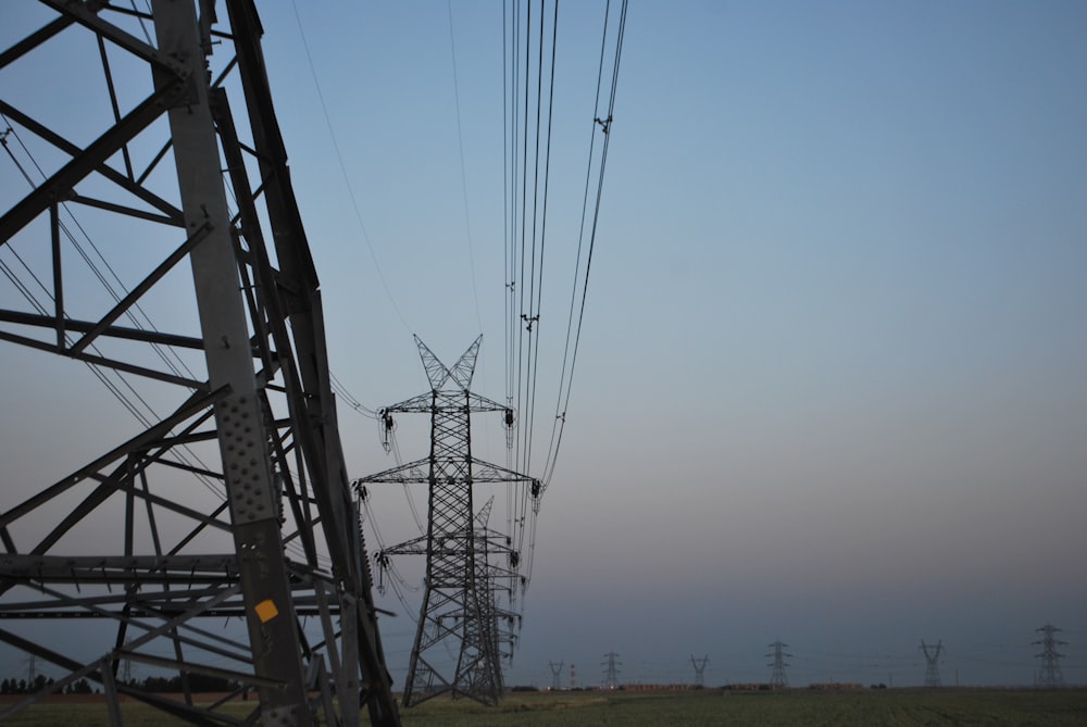 power lines in a field with a blue sky in the background