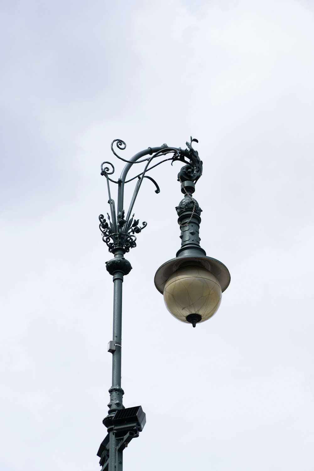 a lamp post with a street light attached to it