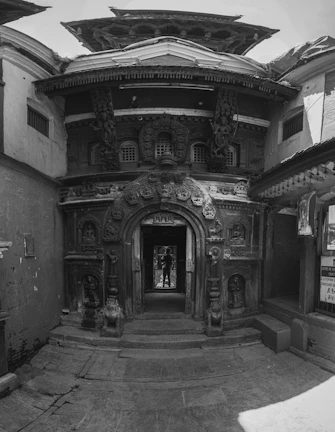 Welcoming entrance of Sarangnest with wooden doors and cultural motifs.