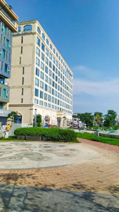 A friendly team of property experts standing in front of a modern residential building.