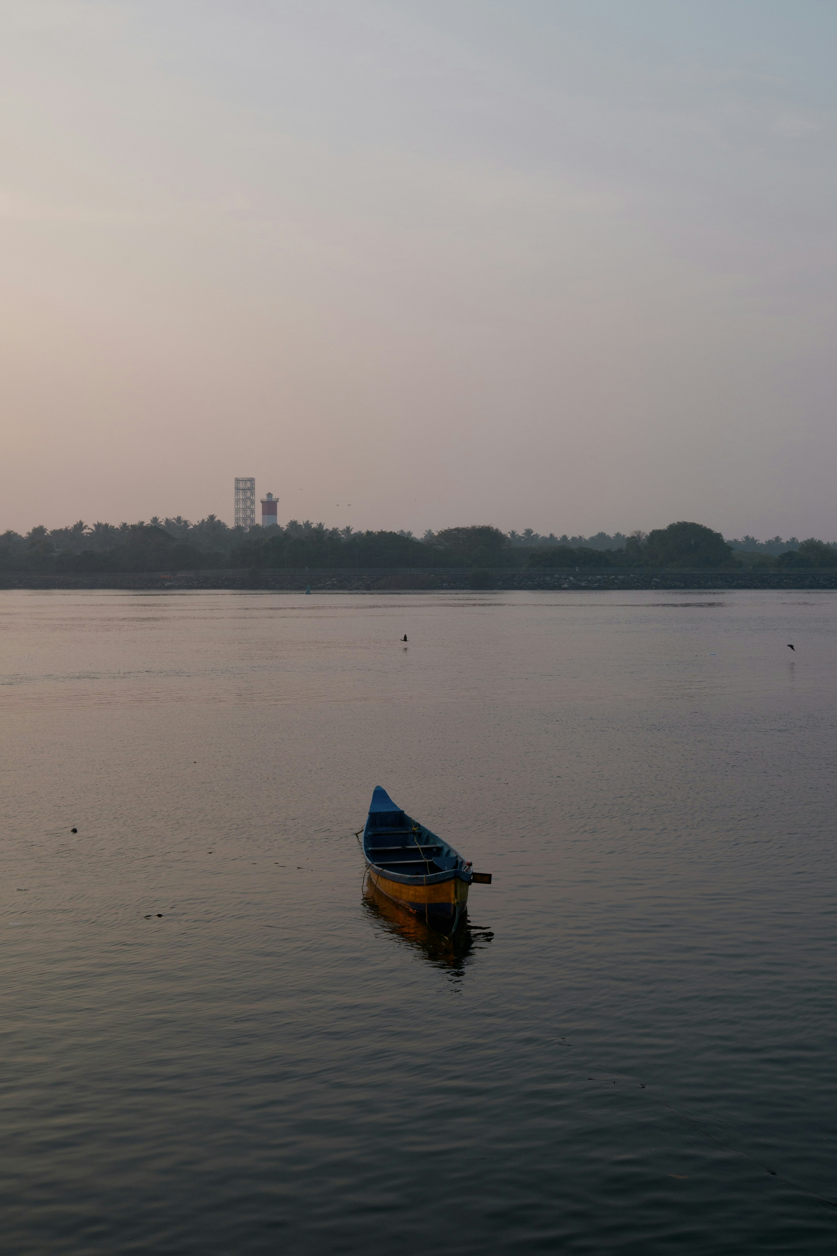a small boat floating on top of a large body of water