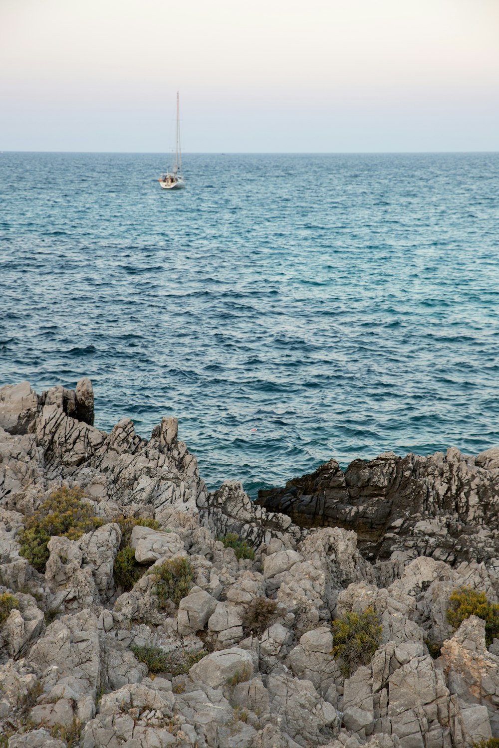 a sailboat is in the distance on the water