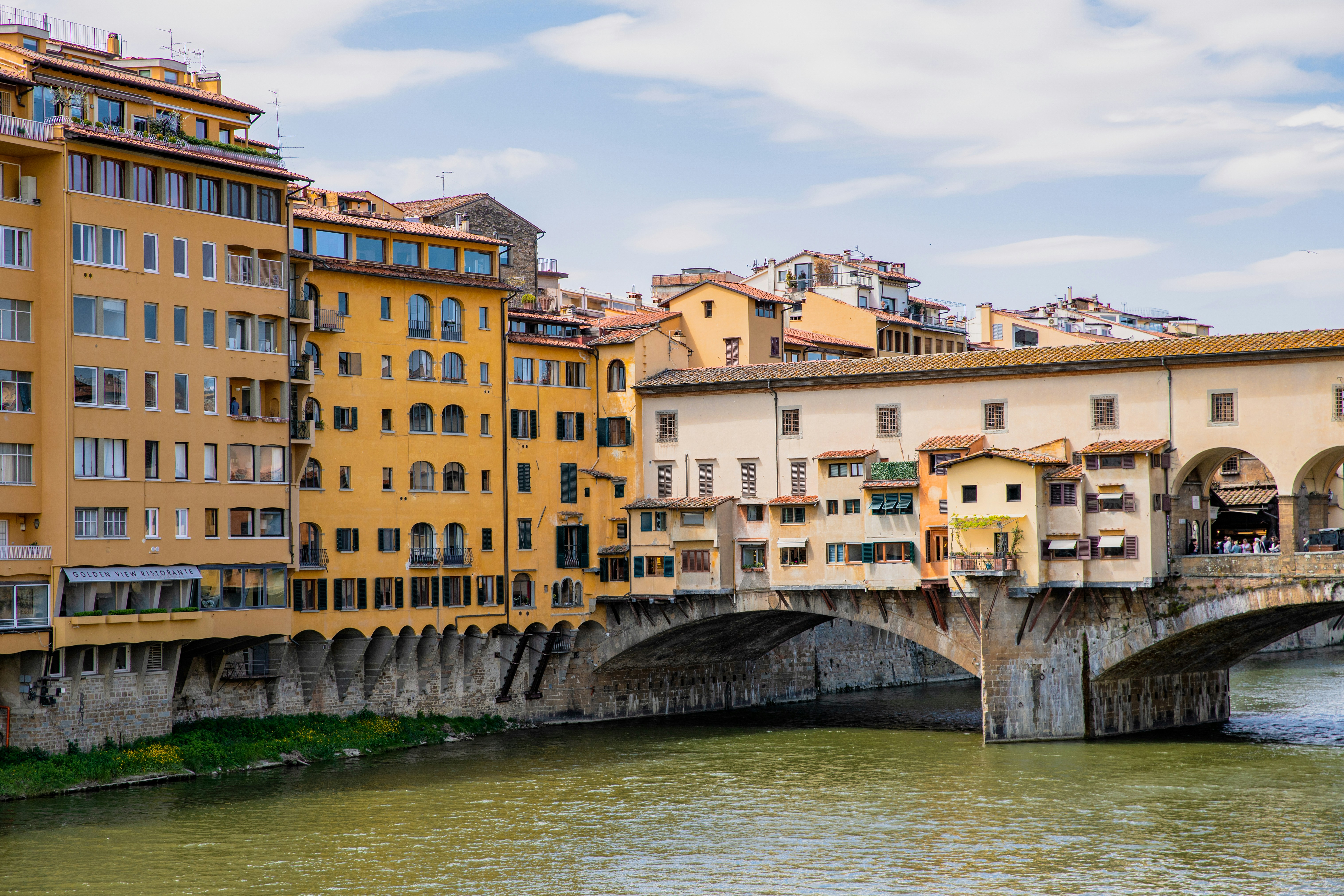 A river running through a city next to tall buildings