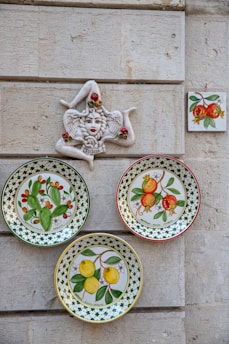 a wall with plates and a statue on it
