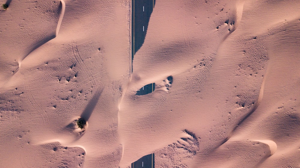 a car driving down a road covered in snow